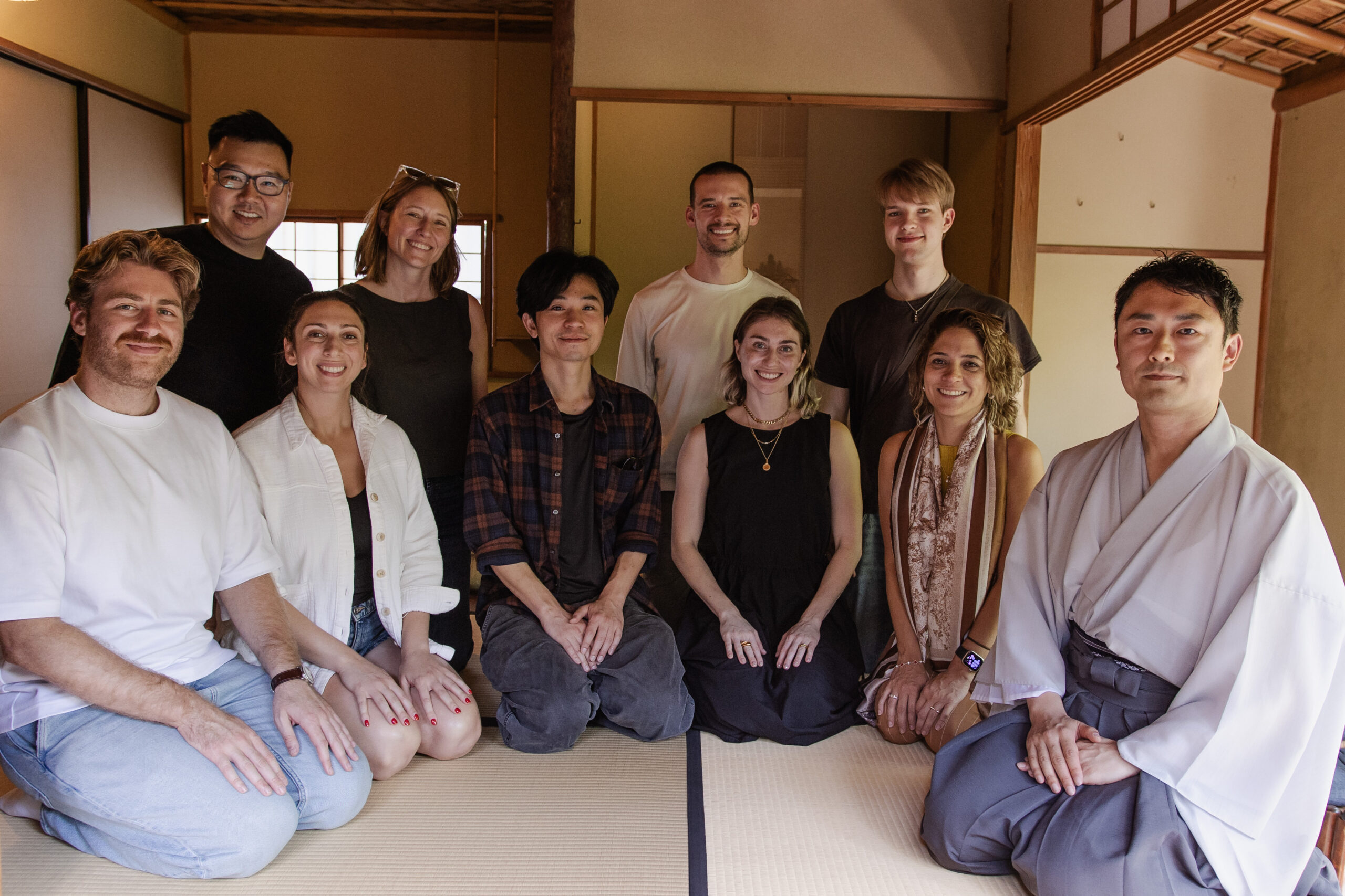 FUTRFEST participants posing with a host wearing a kimono in a traditional tatami room